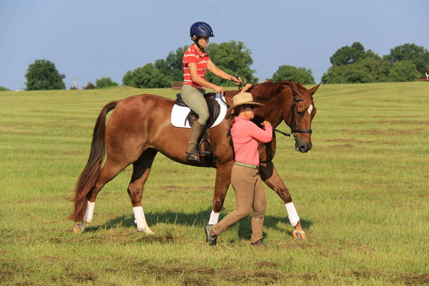 Lellie Ward teaching a rider in a field. 